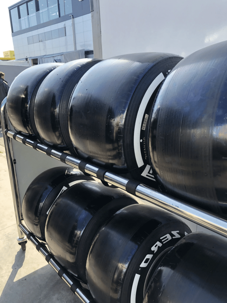 Set of shiny hard F1 tyres on a rack