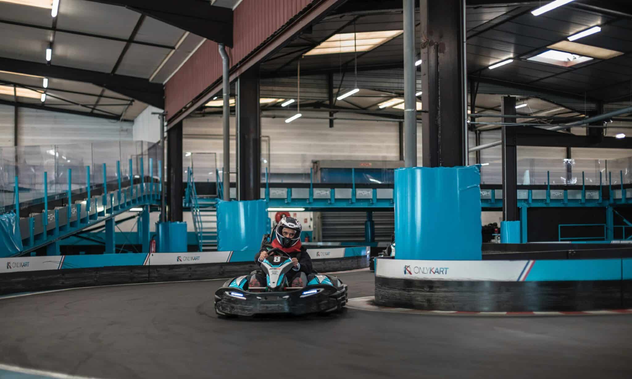 a person riding a go - kart in a building
