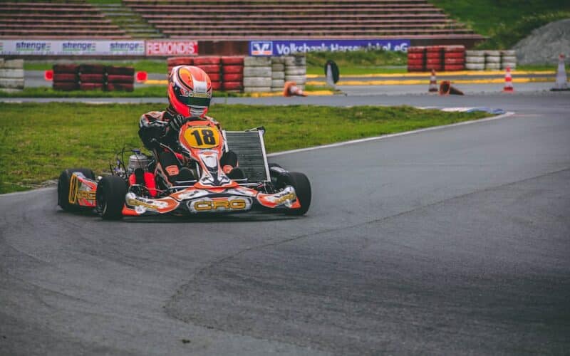 a person riding a go kart on a race track