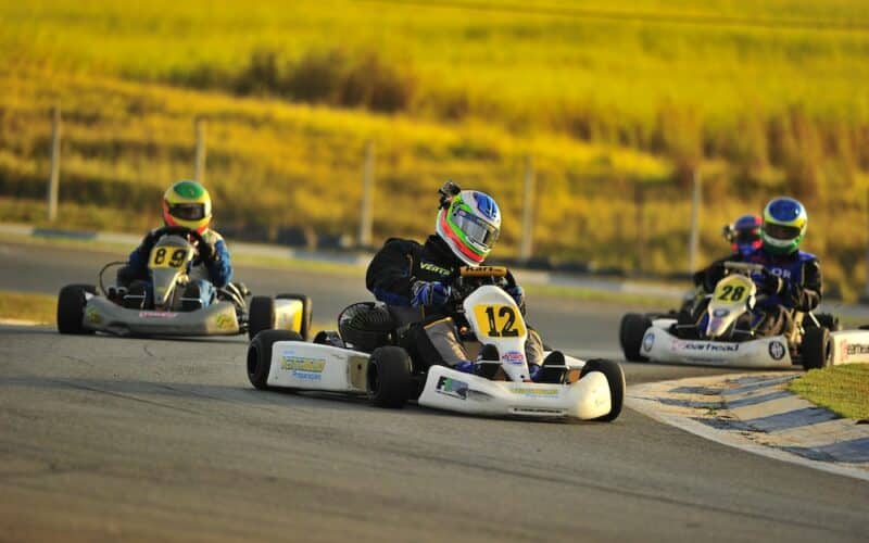 a group of people racing go kart cars on a track