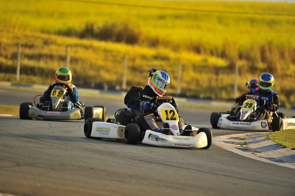 a group of people racing go kart cars on a track