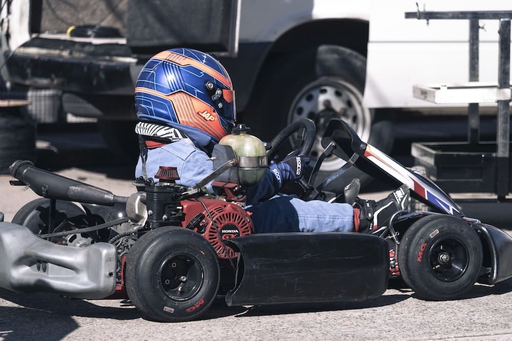 a man sitting in a go kart with a helmet on