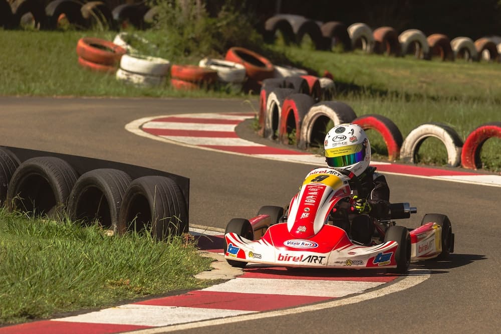 a person driving a go kart on a race track