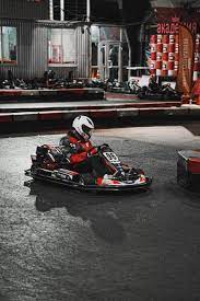 a person riding a go kart in a race track