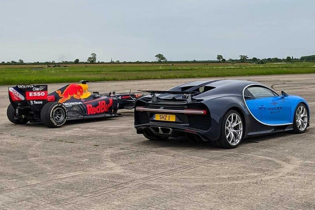 una bugatti e una macchina da corsa Red Bull su una pista