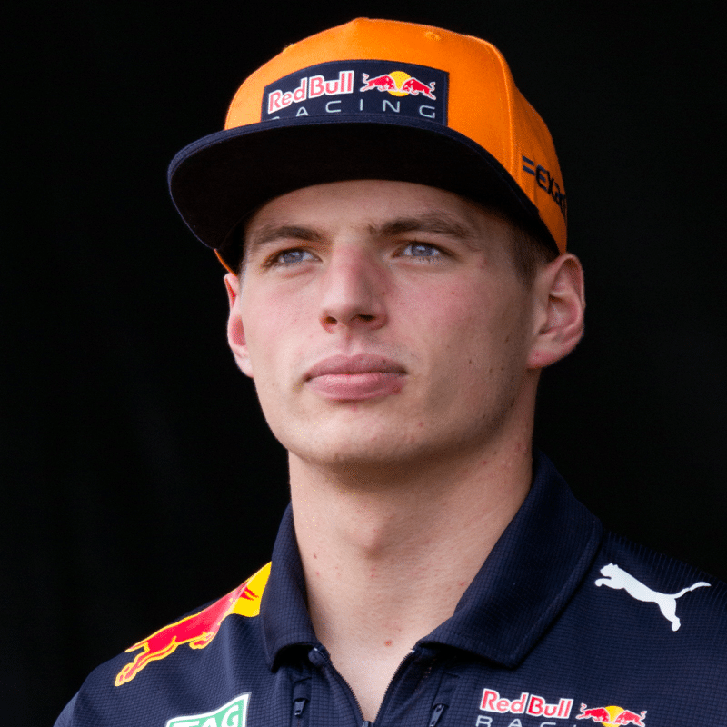 a man wearing a red bull racing hat