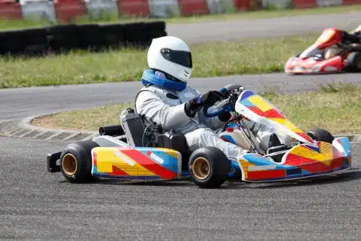 a person riding a go kart on a race track