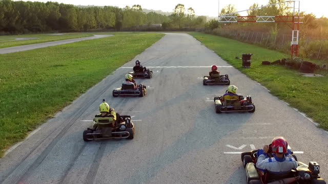 a group of people riding karts down a road