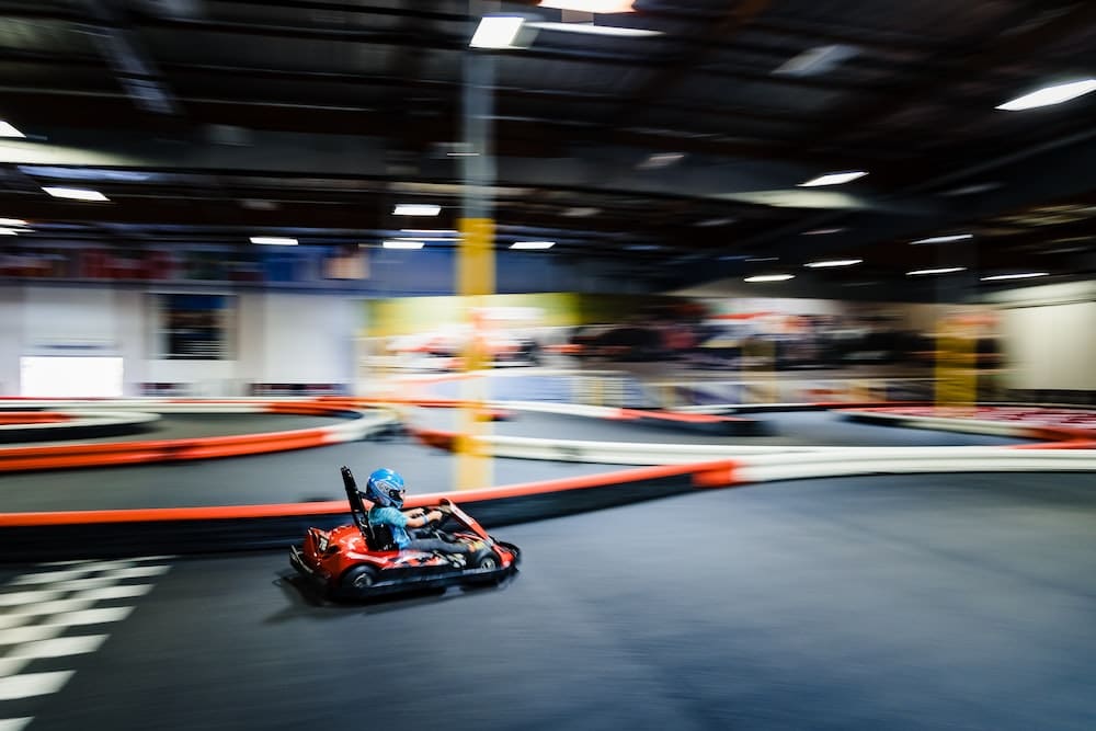 a person riding a go kart in a race track