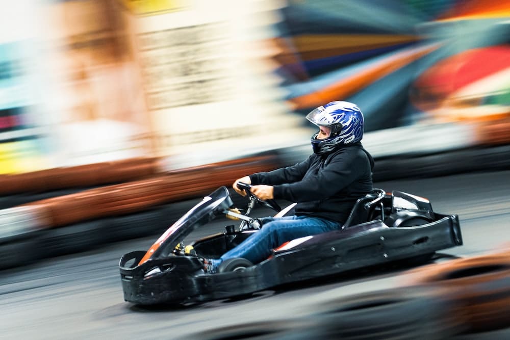 a man riding a go kart down a street