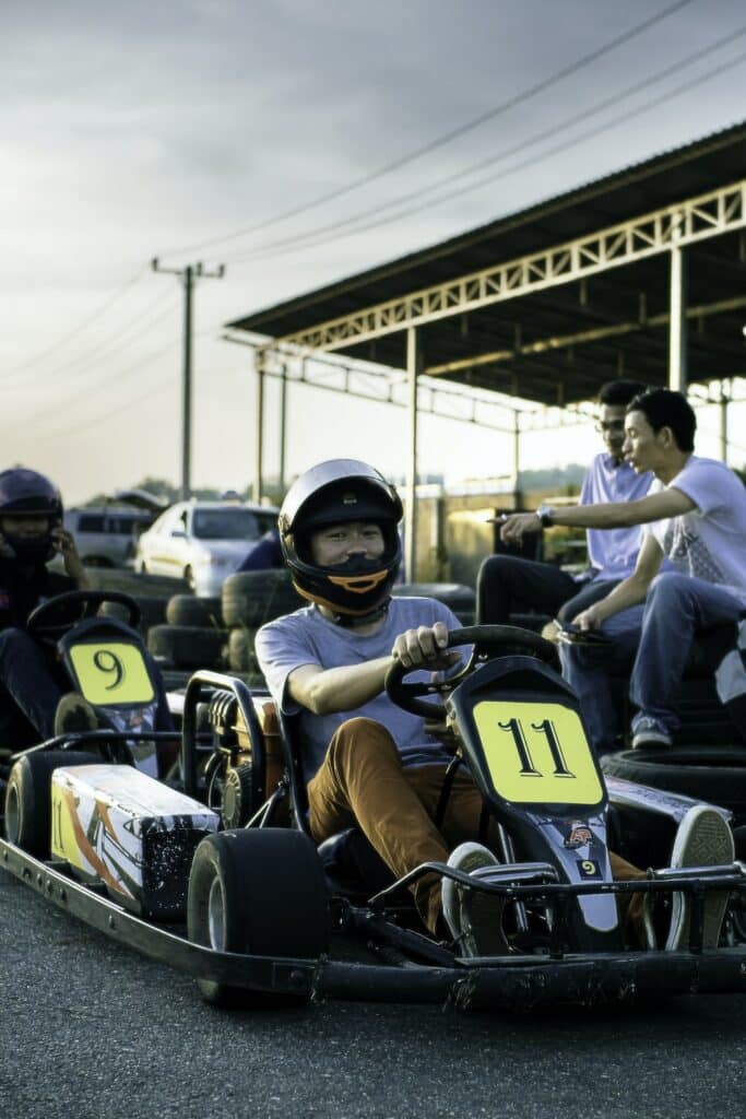 a group of people riding on top of a go kart