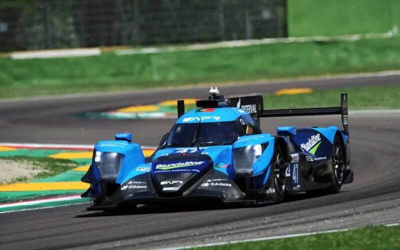 a blue race car driving on a race track