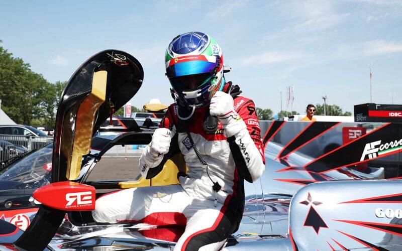 a man sitting on top of a racing car