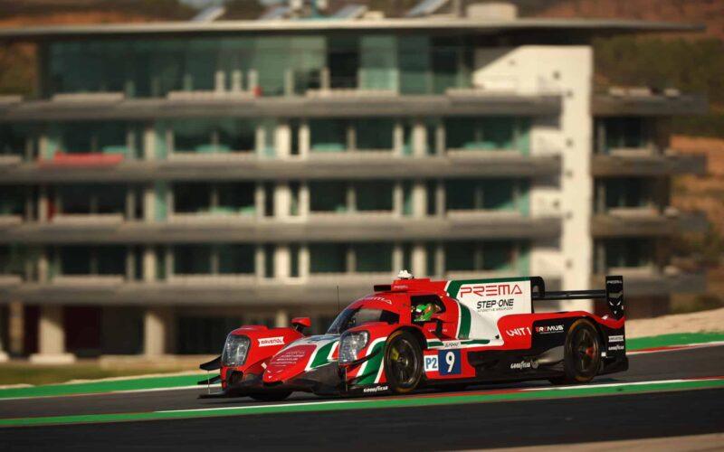 a race car driving on a race track in front of a building
