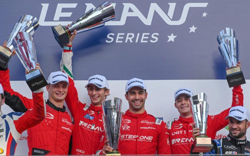 a group of men standing next to each other holding up trophies