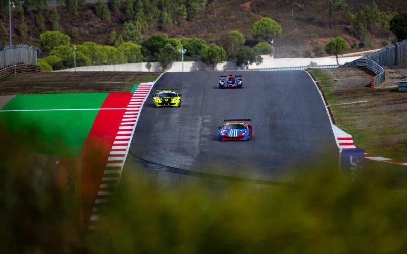 a group of cars driving down a race track