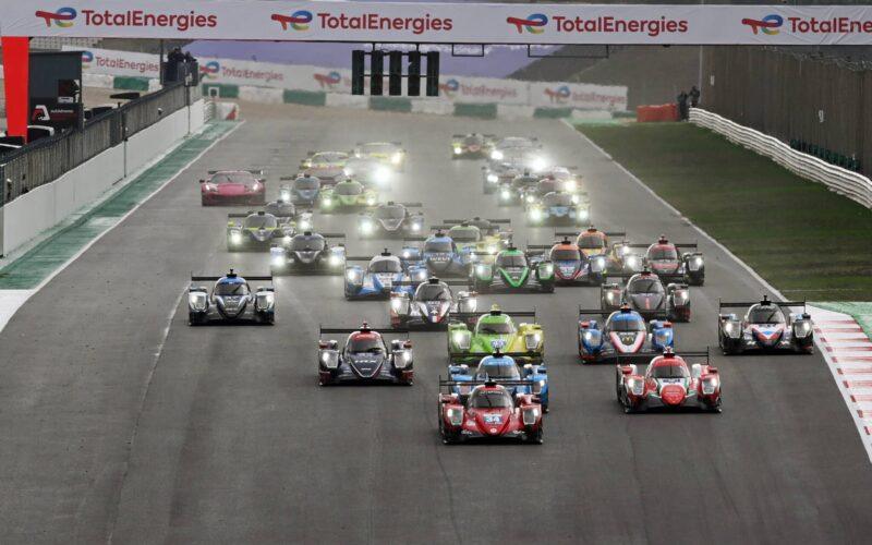 a group of cars driving down a race track