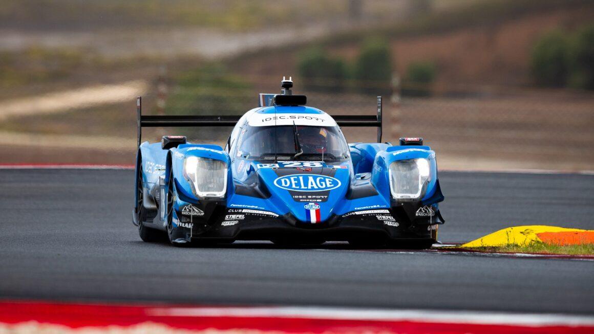a blue race car driving on a race track