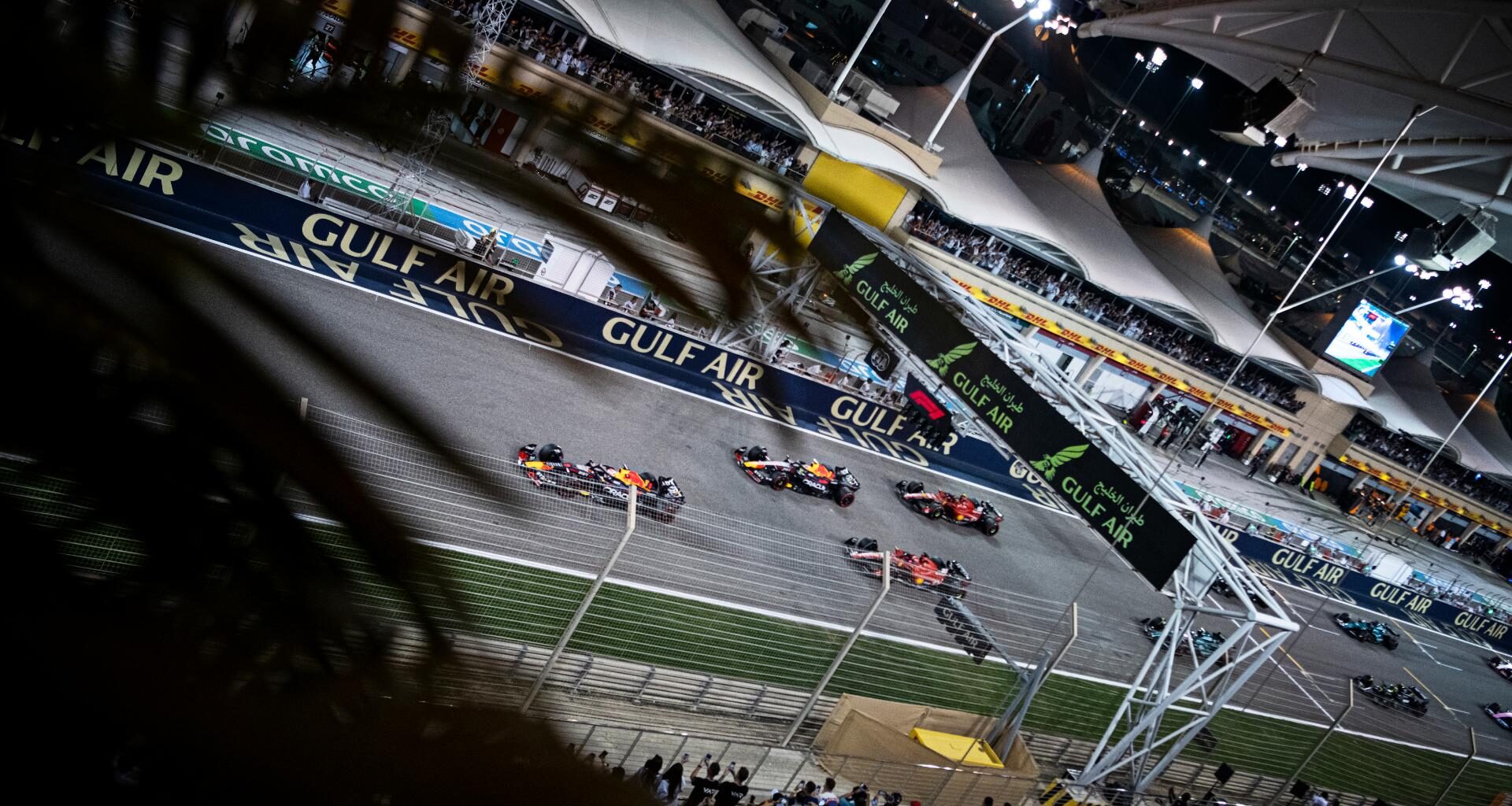 a group of people watching a race on a track