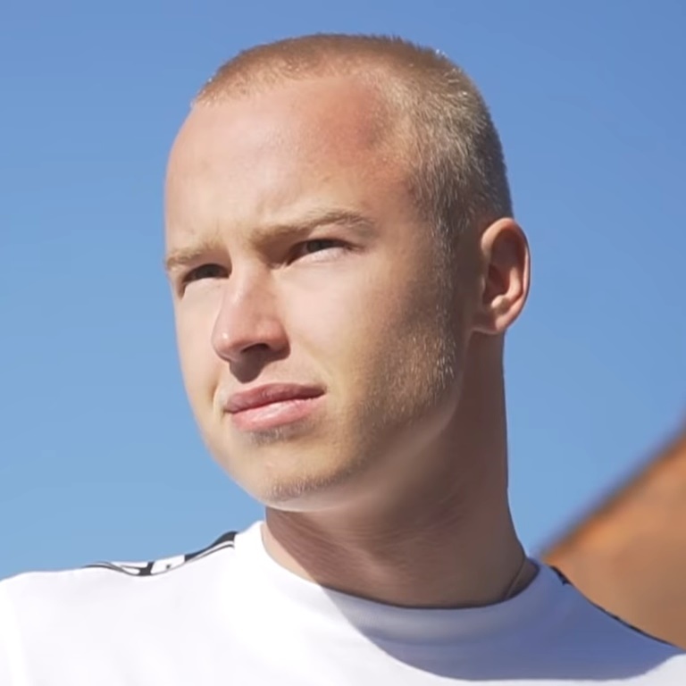 a man with a bald head wearing a white shirt