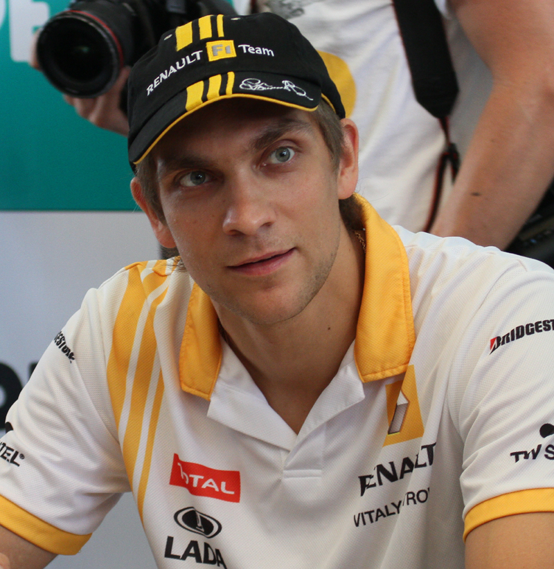 a man in a yellow and white shirt and hat