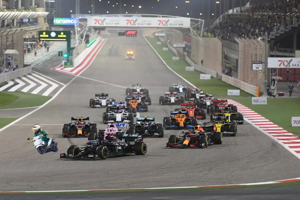 a group of cars driving down a race track