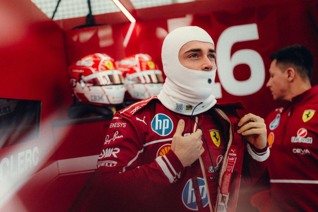 a man in a red racing suit and a man in a white mask